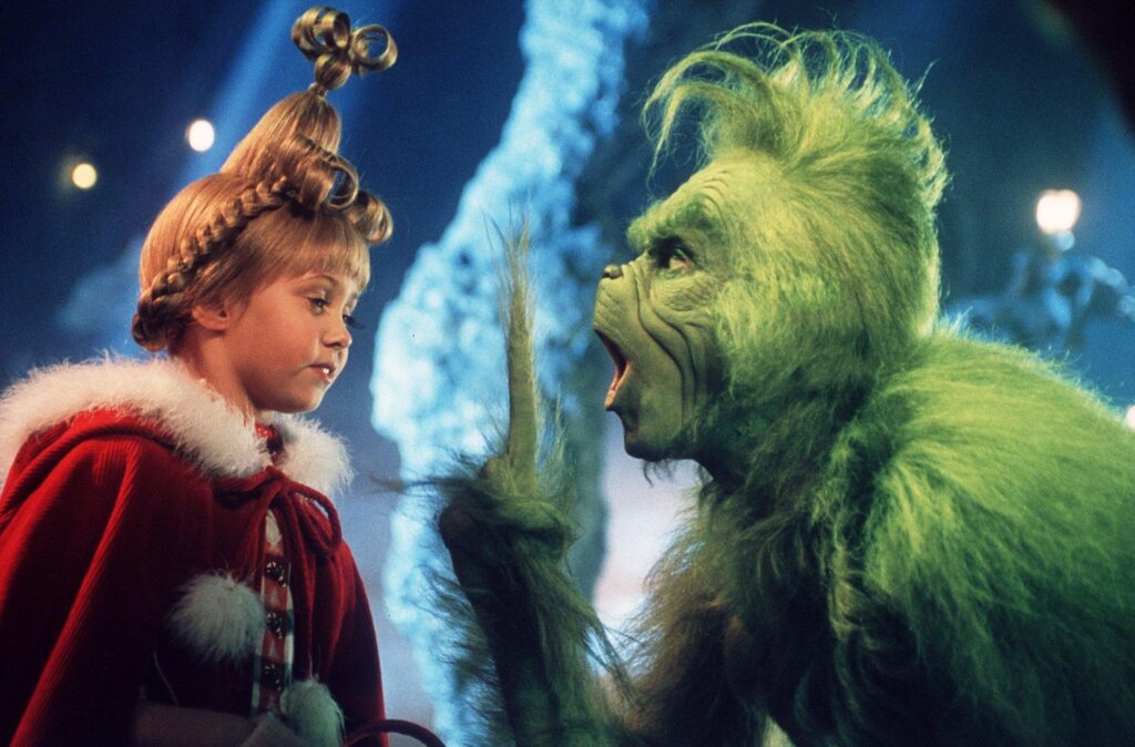 the grinch pointing finger in cindy lou who's face