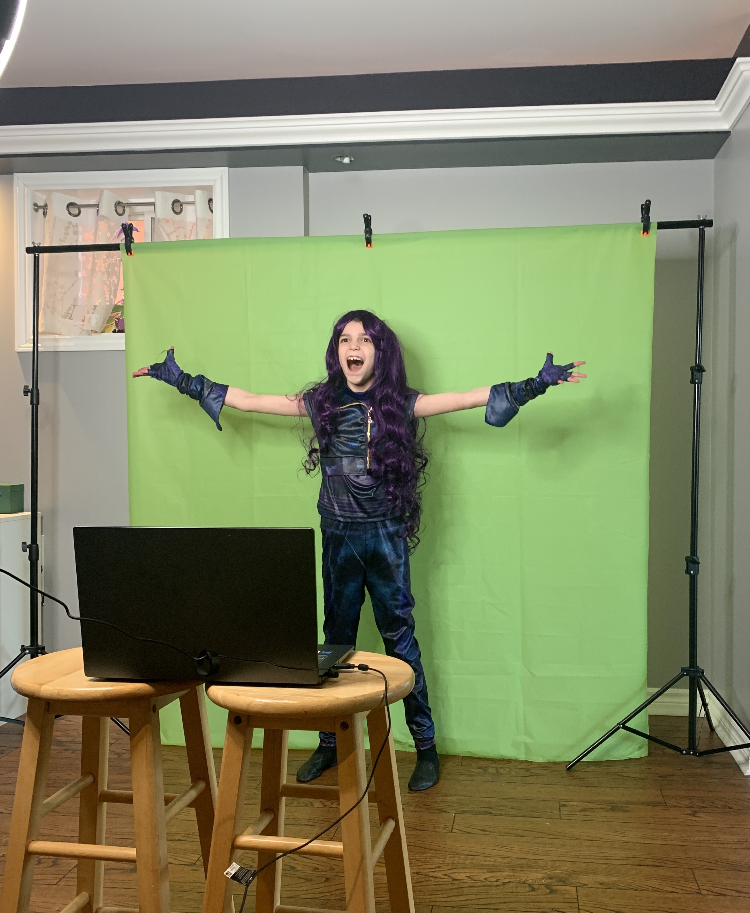 Charlotte on green screen at home in costume