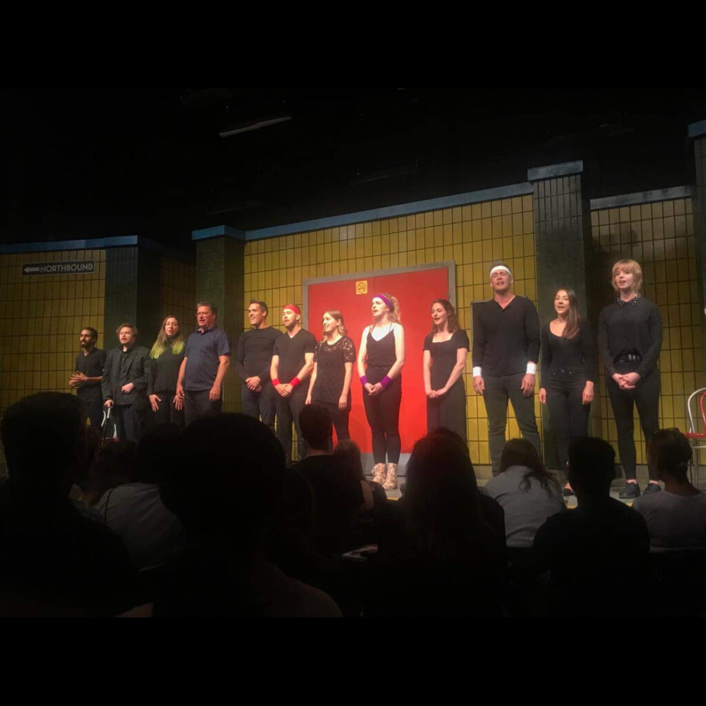 julianne bisnaire cast on stage standing in line wearing black 